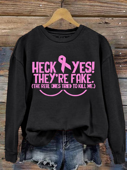 Women's Heck Yes They're Fake The Real One Tried To Kill Me Breast Cancer Awareness Print Sweatshirt